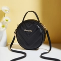 Elegant black circular crossbody bag with V-quilt pattern and gold hardware details - Black