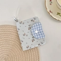 Close-up of floral corduroy coin purse with blue checkered flap and lobster clasp - Blue