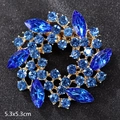 Deep blue rhinestone crystal flower brooch in gold finish, measures 5.3x5.3cm - Rotating Blue Crystal Flower