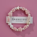 Pink and white star-shaped ceramic beaded bracelet for women on a gift card display - Pink White Round Bone (1586-15)