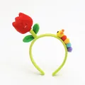 Detail of cute plush tulip and colorful caterpillar elements on a green floral headband - Tulip Red