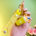 Yellow silicone milk tea cup keychain with donut detail and Pretty Good wrist strap - 3-Piece Set Milk Tea Cup / Yellow