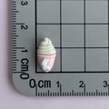 Macro view of 1.5cm pink resin cupcake accessory with white bunny on a grid mat - Rabbit Ice Cream