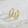 Macro shot of gold-plated hoop earrings with micro-pave white zircon on stone background - 15MM Zirconia Hoop
