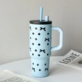 Light blue insulated tumbler with black polka dots and bow design featuring a straw - UV Printed Handle Cup Blue