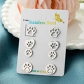 Set of four stainless steel animal paw stud earrings displayed on a white jewelry card - Steel
