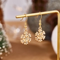 Close-up of golden snowflake earrings with rhinestones on a display stand - Snowflake with Rhinestone Style (E00898G)