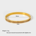 Macro view of 18k gold plated stainless steel bangle with full zircon pavé setting - White