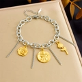 Detail of stainless steel charm bracelet featuring gold flower pendants and coin on jewelry box - 3D Rose Relief Style (B1657)