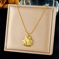 Close-up of gold stainless steel necklace with engraved shell pendant on display box - Shell Floral Pattern Pendant (N3486)