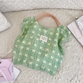 Dettaglio della borsa tote in tela floreale con motivo verde e manico in corda arancione - Loto Verde
