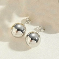 Macro detail of polished silver ball stud earrings with glossy mirror finish and butterfly back - Large / Silver