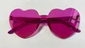 Frameless candy colored heart shaped sunglasses in vibrant translucent rose pink - Dark Purple