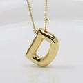 Macro shot of 3D puff initial D pendant in gold finish with thin bead chain - Letter D (Necklace)