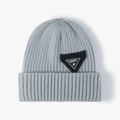 Grey ribbed knit beanie with a decorative black triangle patch and happy embroidery - One Size / Blue-Grey