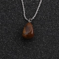 Close-up of a pear-shaped brown tiger eye stone pendant on a silver twist chain necklace - Pear Shaped Brown Stone + 60cm Rope Chain