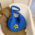Quilted puff tote bag in Klein blue with a yellow floral pendant on a modern white chair - Blue with Pendant