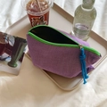 Detail of purple checkered makeup bag with green zipper on a tray in a lifestyle setting - Storage Pouch / Purple Plaid