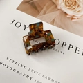 Vintage amber tortoiseshell hair claw clip with blue marble accents for elegant styling - Ink Pattern