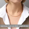 Golden 1mm round snake chain necklace in titanium steel worn by model, 45+5cm length - Snake Chain 45+5cm / Gold