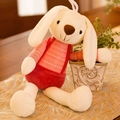 White plush bunny toy wearing red striped overalls on a soft golden tablecloth - 40CM / Red