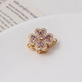 Macro shot of gold floral jewelry clasp with micro-paved zircons and purple stone details - 10# 14K Gold Single Row (15*21mm)
