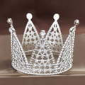 Macro shot of a silver alloy crown with white rhinestones on a brown velvet stand - Seven-Point Full Diamond Silver 01