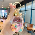 Lucky cat keychain with golden sand beads and bell charm shown in hand - Lucky Cat Flash - Colorful / Individual Packaging