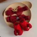 Detail of red baby headband and bow socks gift set on a beige ceramic plate - 4639 Wine Red Headband + Socks