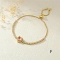 Detail of adjustable gold tennis bracelet with pink heart-shaped crystal and slider clasp - Pink