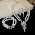 Vista dettagliata di un set di gioielli di lusso con perle e cristalli con orecchini - Set da 3 pezzi / Argento-Bianco