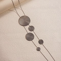Macro shot of long necklace with five circular textured metal pendants in gunmetal finish - Necklace / Gunmetal