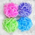 Top view of colorful mesh bath sponges in pink, purple, green and blue on marble tiles - 50g Bright with White Border