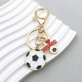 Gouden voetbal sleutelhanger met zwart-witte bedeltjes en een rood soccer plaatje - Voetbal Medaille Hanger (ER770)