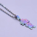 Macro detail of a girl shaped pendant with rainbow metallic finish on a fine steel chain - Girl Necklace - Rainbow