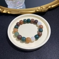Multi-colored weathered Bodhi seed bracelet with cylindrical beads in rich earthy tones - Chocolate Candy Color