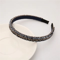 Close-up of baroque style narrow headband featuring navy blue crystals and gold beads - Hematite Color
