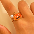 Detail van verstelbare gouden ring met pompoenhanger en parel aan de vinger - Pompoenstijl (01 18K Goud F-095)
