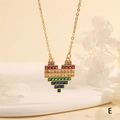 Detailed close-up of a golden heart necklace featuring vibrant rainbow baguette gemstones - Mosaic Rainbow Heart (NE2270-E)