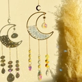Golden moon crystal suncatcher with blue stones and prisms casting colorful light - Aquamarine Moon Wind Chime