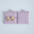 Detail of floral earrings with pearls and rhinestones on purple velvet display cards - Light Purple