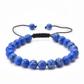 Macro shot of blue natural stone beads with black braided cord and adjustable knot detail - Blue Emperor Stone