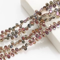 Macro shot of 6x12mm crescent crystal pendants with iridescent metallic gradient finish - Half Brilliant Purple
