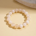Detail of cream acrylic beaded bracelet with marble texture on minimalist stone base - White