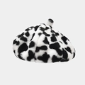 Detail view of plush cow print beret showing soft faux fur texture and top tab detail - One Size / Leopard White