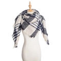 Soft checkered triangle scarf in black, white, and beige with fringe trim on a mannequin - Beige