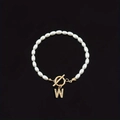 Faux pearl beaded bracelet with gold-tone rhinestone initial charm on black background - Gold Letter W (SL2013)