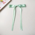 Detail of mint green satin ribbon hair clip with long streamers on white background - Ribbon Duckbill Clip / Mint Green
