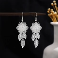 Vintage silver hollow flower earrings with leaf tassels hanging on a wooden pin - Floral Hollow Leaf Tassel Style (E5243)