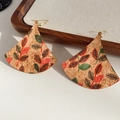 Macro detail of fan-shaped cork earrings with red and green leaf print on gold hooks - Ear Hook-Multicolor-Fan Shaped